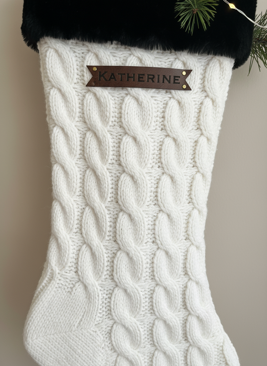 Leatherette tag on white cable knit Christmas stocking
