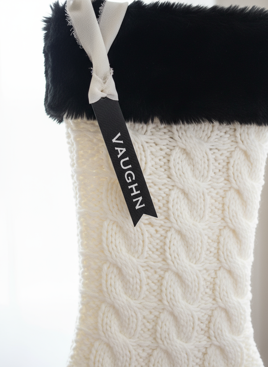 Leatherette tag on white knit Christmas stocking